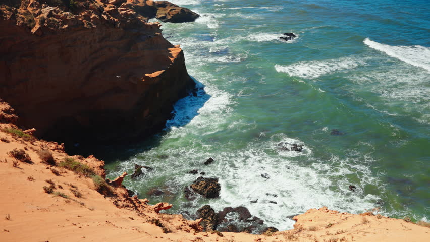 Closeup shot of the rocky coastline at Tamri sand dunes in Morocco. Arid natural desert landscape.