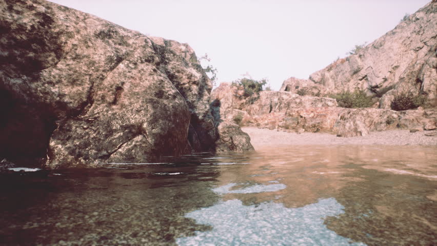 A tranquil body of water embraced by magnificent rocky cliffs in Portugal.