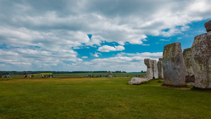 Dramatic timelapse records drifting clouds and sunlight as they cross the stone circle of Stonehenge, Salisbury, Wiltshire, England, UK
