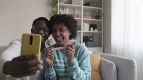 Happy couple sharing positive pregnancy test result during video call. Excited couple sharing pregnancy test result on video call in slow motion - Powered by Shutterstock - Get 15% off with code: PIKWIZARD15