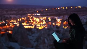 Woman Working on Laptop Under Full Moon with Cappadocia View - Powered by Shutterstock - Get 15% off with code: PIKWIZARD15