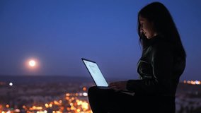 Woman Working on Laptop Under Full Moon with Cappadocia View - Powered by Shutterstock - Get 15% off with code: PIKWIZARD15