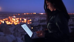 Woman Working on Laptop Under Full Moon with Cappadocia View - Powered by Shutterstock - Get 15% off with code: PIKWIZARD15