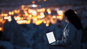 Woman Working on Laptop Under Full Moon with Cappadocia View - Powered by Shutterstock - Get 15% off with code: PIKWIZARD15