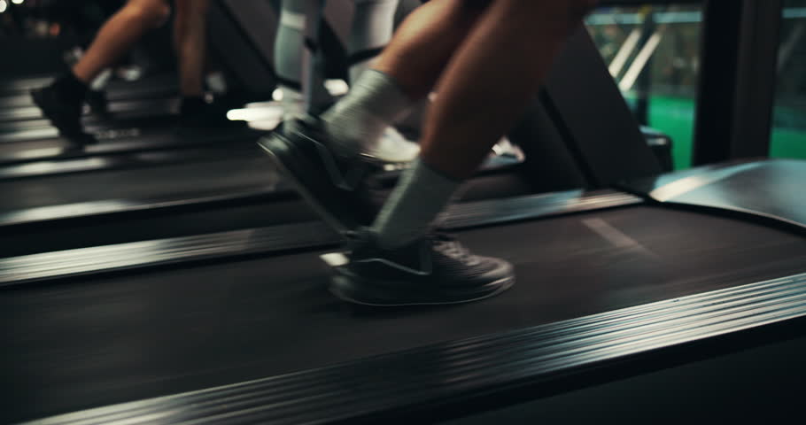 Sneakers, legs and running on treadmill in gym, active and training with energy, speed and cardiovascular health. Runner, shoes and person on exercise equipment, machine and workout at fitness center