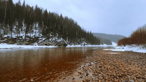 The icy river Usva in winter, flowing through a rocky area in the Perm region, stone pillars. Winter on the banks of the Usva mountain river.Russia, Ural Mountains. Frozen river covered with snow.4K - Powered by Shutterstock - Get 15% off with code: PIKWIZARD15