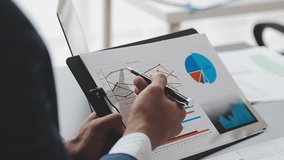 Financial Business team present. Business man hands hold documents with financial statistic stock photo, discussion, and analysis report data the charts and graphs. Finance Financial concept Video - Powered by Shutterstock - Get 15% off with code: PIKWIZARD15