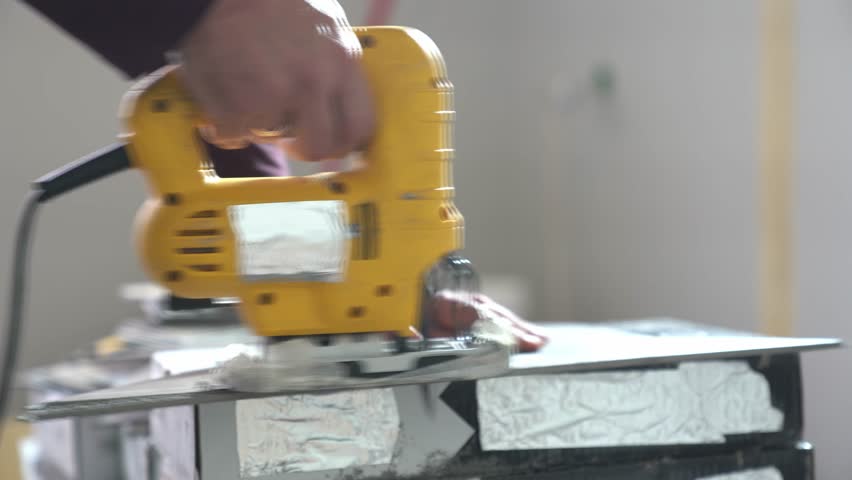 Electric jigsaw for manual cutting of hard plates. Hand saw with modern sawing technology. High quality 4k footage