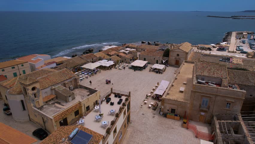 Marzamemi market square. Calm seaside water and historic old town and fishing port in Sicily, Italy