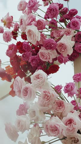 Vertical video. A Beautiful and Aesthetic Arrangement of Lovely Pink and Red Roses Enhancing Any Space
