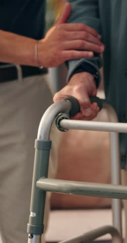 Hands, walker and old man with help from caregiver in home, support or assistance for mobility, recovery or rehab. Healthcare worker, senior patient and guide for walking, balance and elderly care
