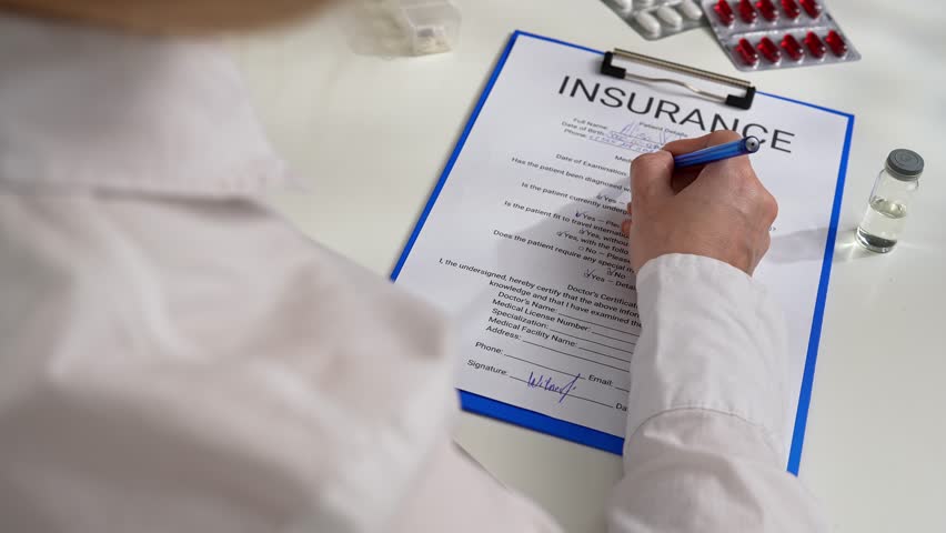 Documenting a life and health insurance form in the office of a hospital or insurance agency. A person is carefully filling out an insurance form with a pen, ensuring accuracy and attention to detail.