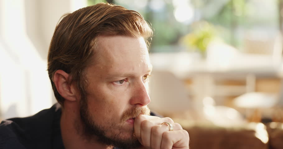 Home, stress and man with thinking on sofa for worry, reflection and regret decision. Mental health, anxiety and person with contemplation in apartment for uncertainty, remember mistake and doubt