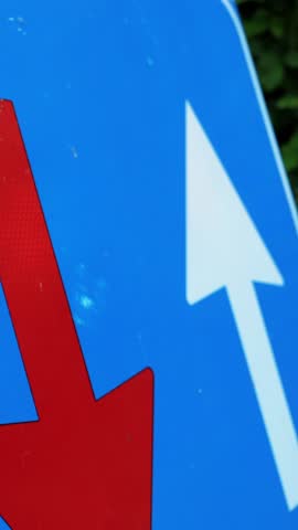 Traffic sign. blue square with red and white arrows. Road works sign. close-up. Repair work is underway on the road. Attention. road repair. big bridge in the alpine mountains. summer day.