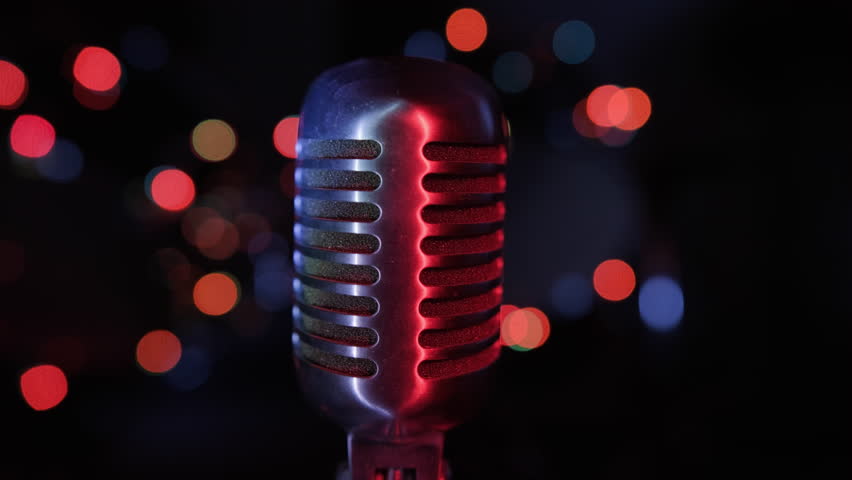Singer hand taking retro vintage microphone on stage close up. Start of performance.