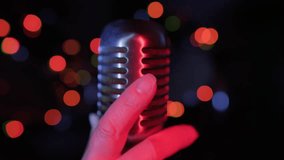 Singer hand taking retro vintage microphone on stage close up. Start of performance. - Powered by Shutterstock - Get 15% off with code: PIKWIZARD15