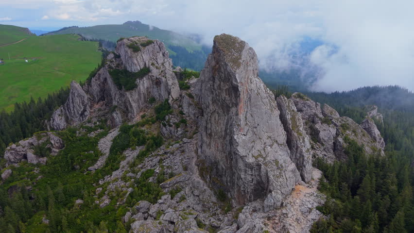 Majestic rock formations of Pietrele Doamnei shrouded in ethereal mist, Carpathians, Romania