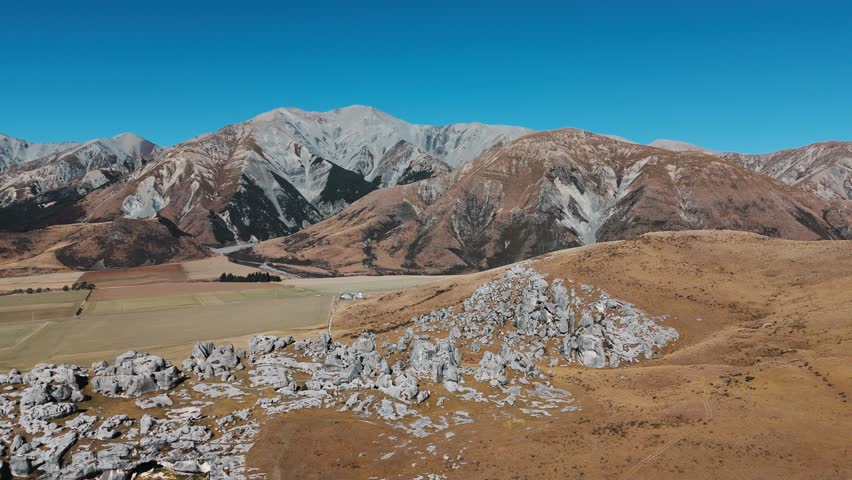Wide drone establishing of sacred Castle Hill rock structures in Arthur’s Pass, New Zealand