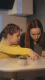 Focused little girl and mother connecting jigsaw puzzle pieces, relaxing pastime - Powered by Shutterstock - Get 15% off with code: PIKWIZARD15