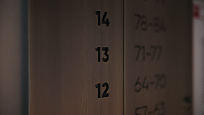Floor and apartment number guide near elevator