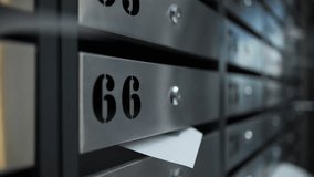 Mailboxes in apartment building with envelope in slot - Powered by Shutterstock - Get 15% off with code: PIKWIZARD15