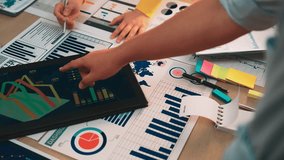 A diverse business team analyzes financial data in a modern office, using charts, graphs, and digital tools to discuss strategy and enhance decision-making processes. SACTR - Powered by Shutterstock - Get 15% off with code: PIKWIZARD15