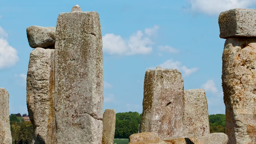 A symmetrical circle of prehistoric stones etched against the pastoral backdrop of Salisbury Plain under sweeping skies, Stonehenge, Salisbury, Wiltshire, England, UK
