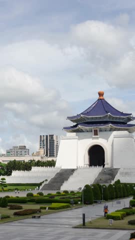 vertical time lapse landscape view at Chiang Kai Shek Memorial hall beautiful architecture building famous tourist landmark national monument in Taipei City of Taiwan among sunny day time