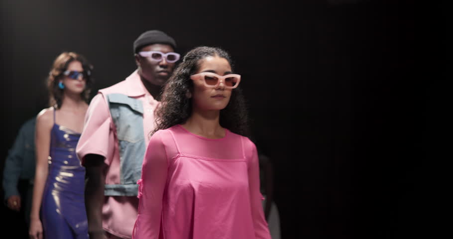 Fashion, show and runway with model at event for designer collection, clothing showcase and couture. Fabric, wardrobe and luxury catwalk with people walking on stage for trendy, and style industry