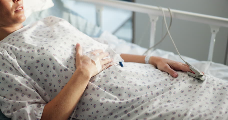 Pain, healthcare and woman in hospital bed, IV drip and medical emergency with recovery. Resting, person and patient in clinic, healing and illness with disease, morphine and cancer diagnosis