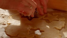 In the kitchen, a mother and daughter make star shaped cookies from shortcrust pastry. The detail and hands are in the frame in the sunlight from the window. - Powered by Shutterstock - Get 15% off with code: PIKWIZARD15