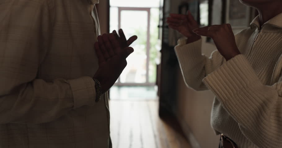 Couple, hallway and hands with argument, stress and drama at home or apartment. Frustrated, woman and man with fight, angry conflict and anxiety with toxic marriage and mistake or crisis with partner