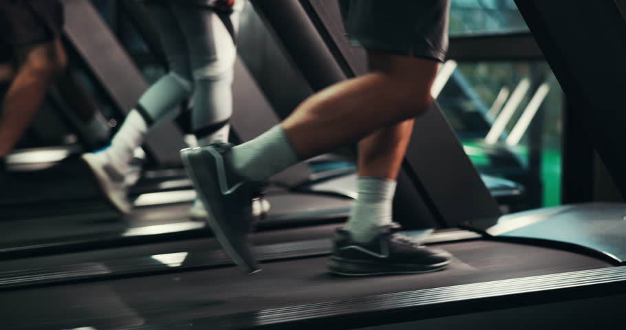 Shoes, legs and running on treadmill in gym, active and training with energy, speed and cardiovascular health. Runner, sneakers and person on exercise equipment, machine and workout at fitness center