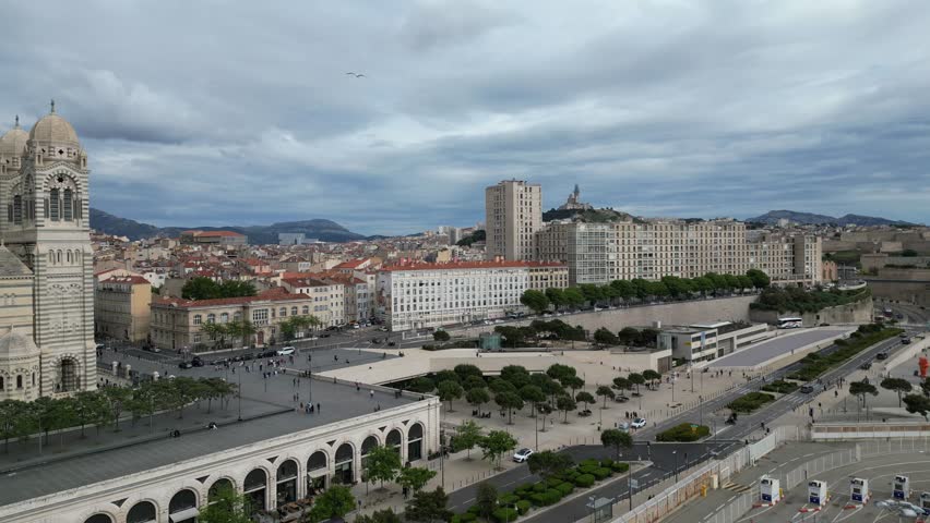 Aerial view of Marseille, France, showcasing the impressive Cathédrale La Major. The city features modern and historical architecture. Travel videos, tourism, background plates for documentaries