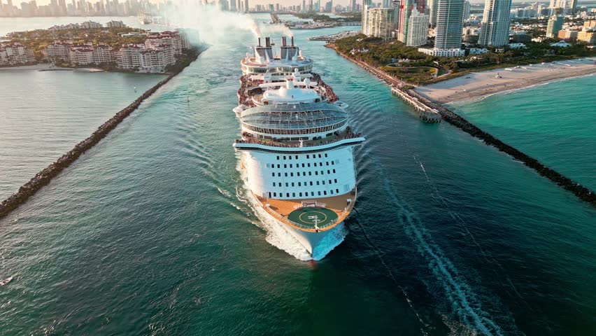Aerial view of luxury liner voyage. Ship leaving Miami beach port. Miami tour. Cruise ship voyage. Aerial view of cruise in summer vacation. Cruise ship tour and travel at sea. Miami Bay cruise
