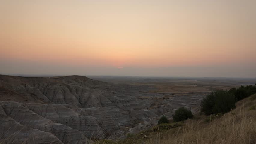 Time-lapse of sunrise over Badlands of South Dakota on a hazy day