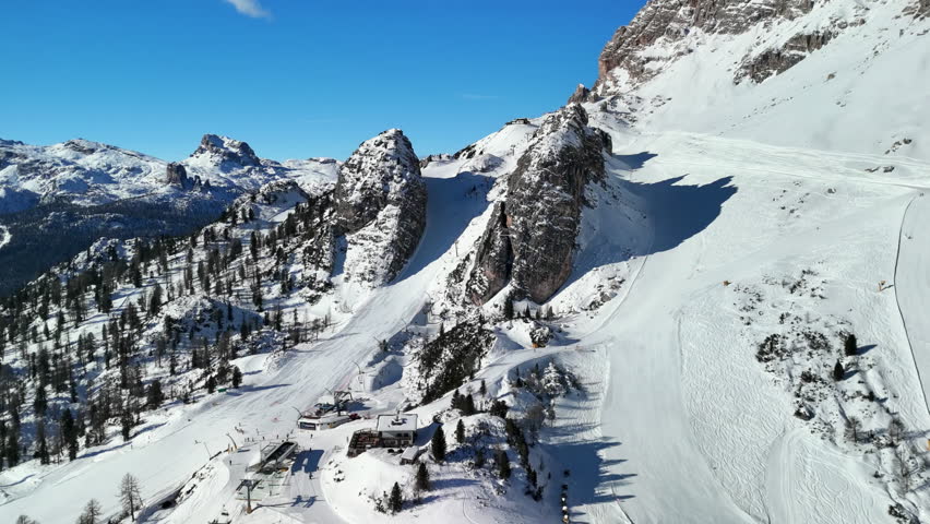 Cortina d'Ampezzo, Italy: Aerial view of famous ski resort in Dolomites (Dolomitic Alps)  and venue of Winter Olympics Milano Cortina 2026, sunny day - landscape panorama of Europe from above