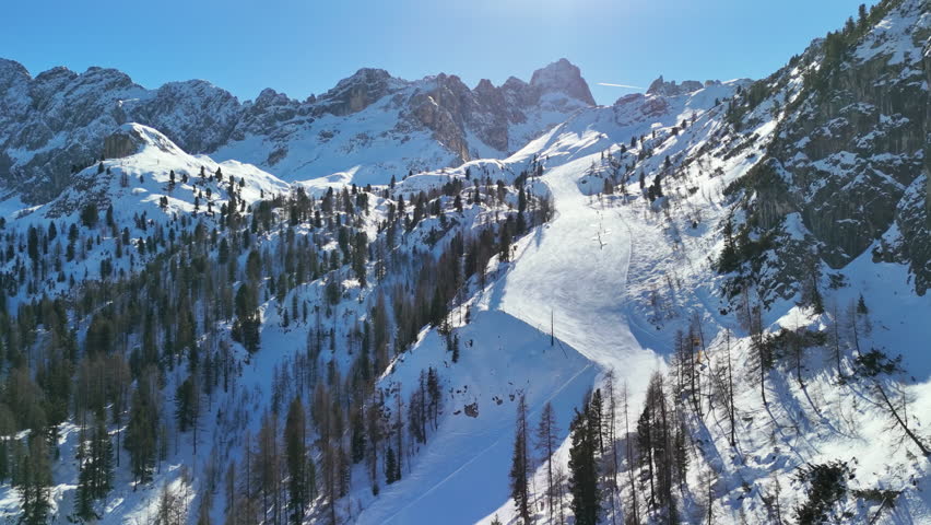 Cortina d'Ampezzo, Italy: Aerial view of famous ski resort in Dolomites (Dolomitic Alps)  and venue of Winter Olympics Milano Cortina 2026, sunny day - landscape panorama of Europe from above