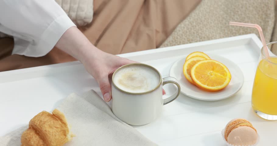 Woman having delicious breakfast in bed, closeup