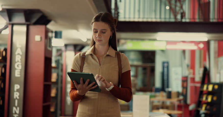 Woman, tablet and walking in library, education and online reading with social media. People, scholarship and students with tech, knowledge or learning with digital app, email or college with network