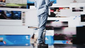 Young modern person focused on his smartphone app and scrolling on social pages, texting his friends and creating quality content for global reach. Cool guy on web connection. Camera B. - Powered by Shutterstock - Get 15% off with code: PIKWIZARD15