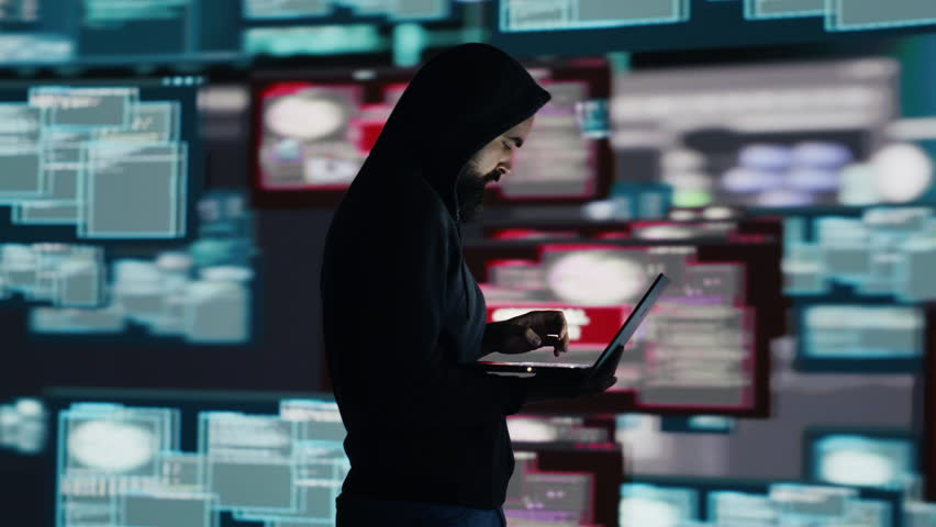 Conceptual representation of cyber crime with male hacker exploiting system vulnerability, using programming technique and surveillance to override digital defenses and leak information. Camera A.