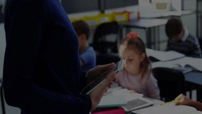 Teacher swiping tablet causing equalizer bars and waveform for boosting classroom learning. Education, digital, data, analysis, technology, classroom, learning - Powered by Shutterstock - Get 15% off with code: PIKWIZARD15