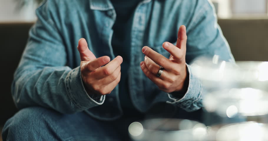 Hands, man and fidget with anxiety on sofa with stress, mental health and overthinking risk. Male person, stimming and worry with panic attack for fear, phobia and trauma crisis with trigger at house