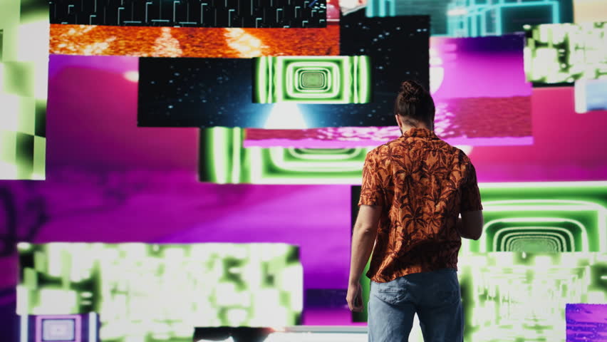 Young carefree man takes selfies and videos surrounded by fun neon lights and beats, representing the fusion of modern DJ culture, media influence and digital art for performance. Camera B.
