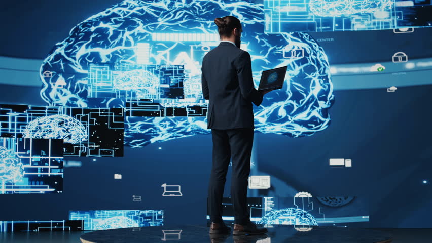 Male business person studies artificial intelligence strategy and automation tools. Surrounded by data visualization, neural networks and cloud computing, he explores smart technology. Camera B. - Powered by Shutterstock - Get 15% off with code: PIKWIZARD15