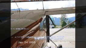 Analog static flickering initiating camera panning over vintage plane fuselage revealing timestamp. Aviation, nostalgia, adventure, aircraft, landscape, retro, open sky - Powered by Shutterstock - Get 15% off with code: PIKWIZARD15