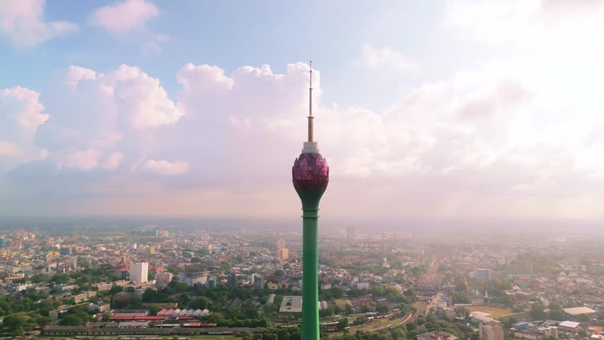 Stunning aerial footage of the Lotus Tower in Colombo, Sri Lanka, surrounded by the cityscape at sunset - perfect for tourism, architectural, and promotional conceptual use.