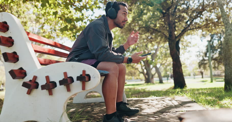 Man, phone and headphones on park bench with fitness, rest or chat on web with inspiration in summer. Person, smartphone and listen to music on mobile app, break or social media at training in Mexico