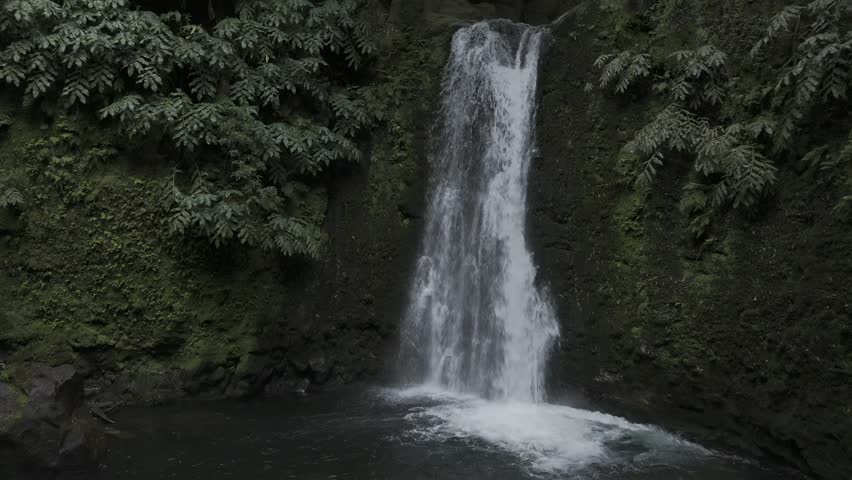 Drone flies in close up of Cascata do Salto do Prego waterfall in Sao Miguel, Azores, Portugal